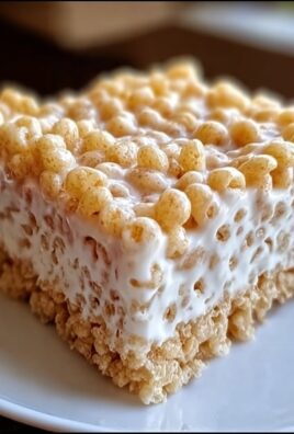 Close-up of a marshmallow cereal bar with crispy layers and gooey melted marshmallow