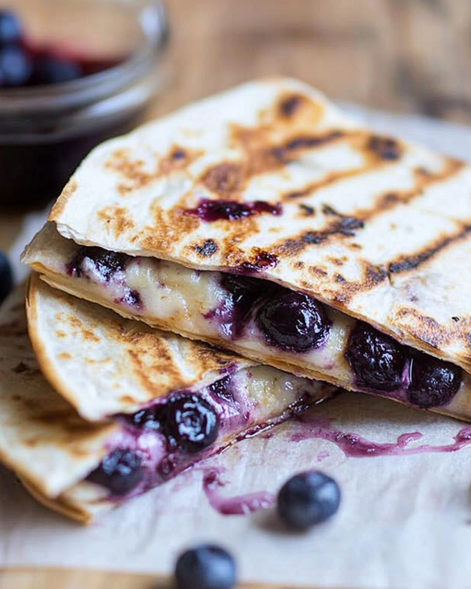 Close-up of grilled blueberry breakfast quesadilla with melted cheese and fresh blueberries