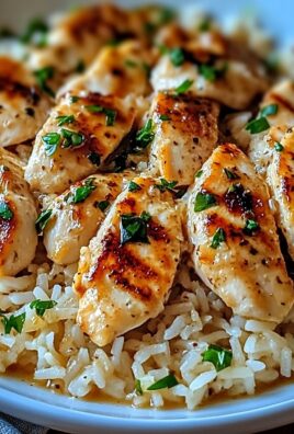 Juicy chicken tenders served over garlic Parmesan rice and garnished with fresh herbs
