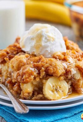 Warm banana cobbler topped with vanilla ice cream and drizzled with syrup