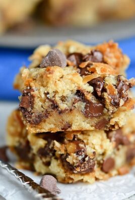 Stack of gooey coconut toffee chocolate chip cookie bars with melted chocolate chips and golden crust