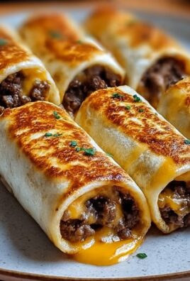 Crispy cheeseburger tacos filled with ground beef and melted cheddar on a plate